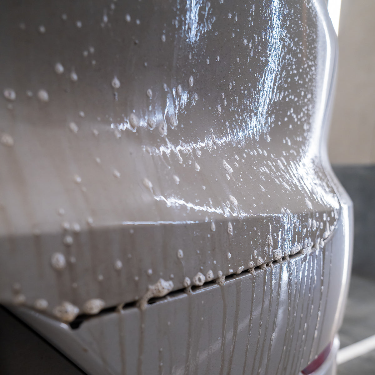 Car being washed with soap suds on the surface