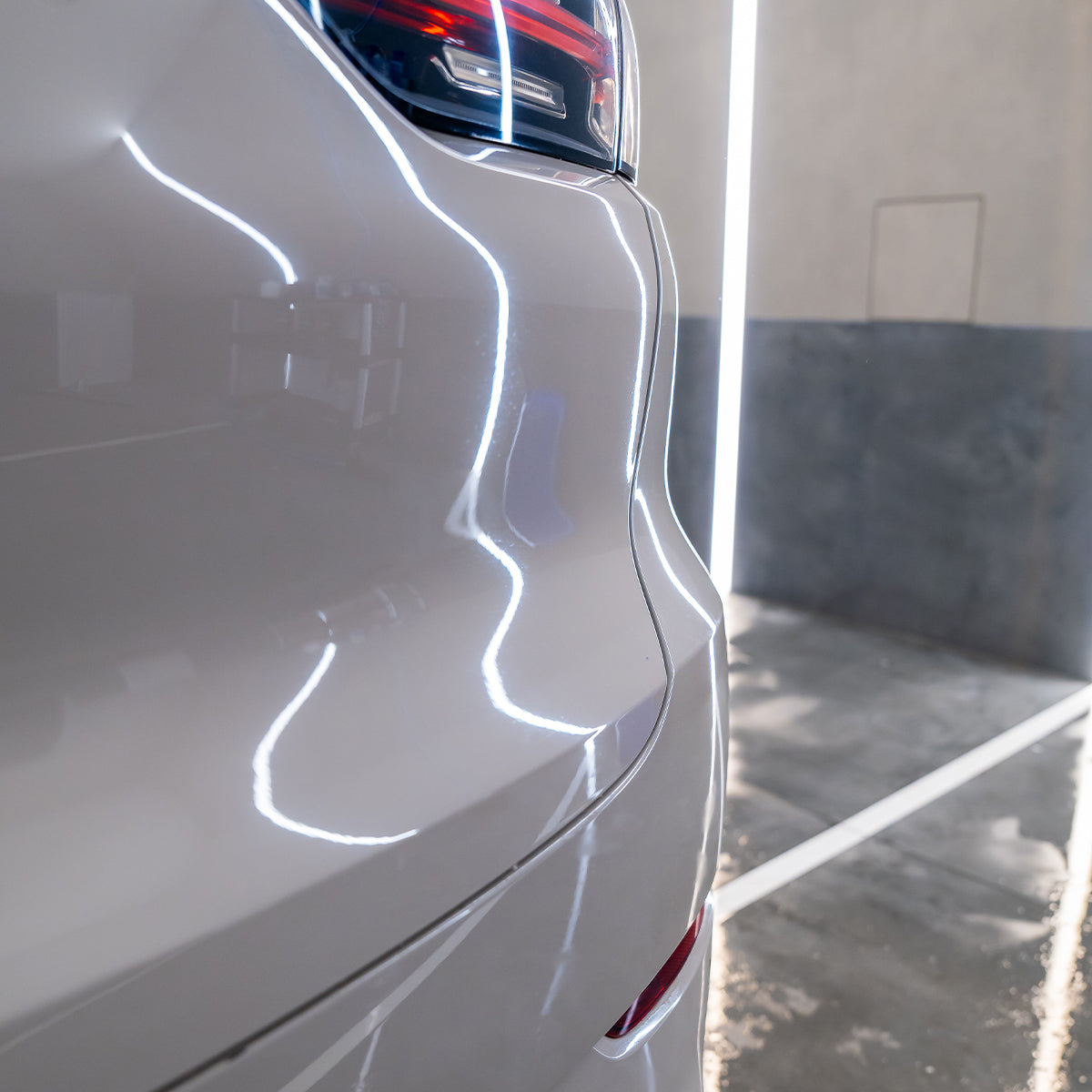 Close-up of a white car&#39;s side panel with a blurred background
