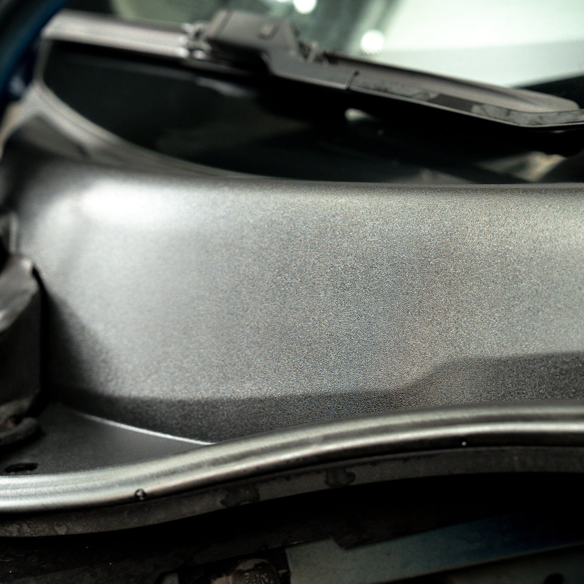 Close-up of a car&#39;s hood with a textured surface